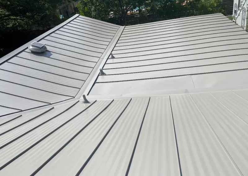 Solar attic fan installed on a metal roof for Roof Ventilation in Pittsford